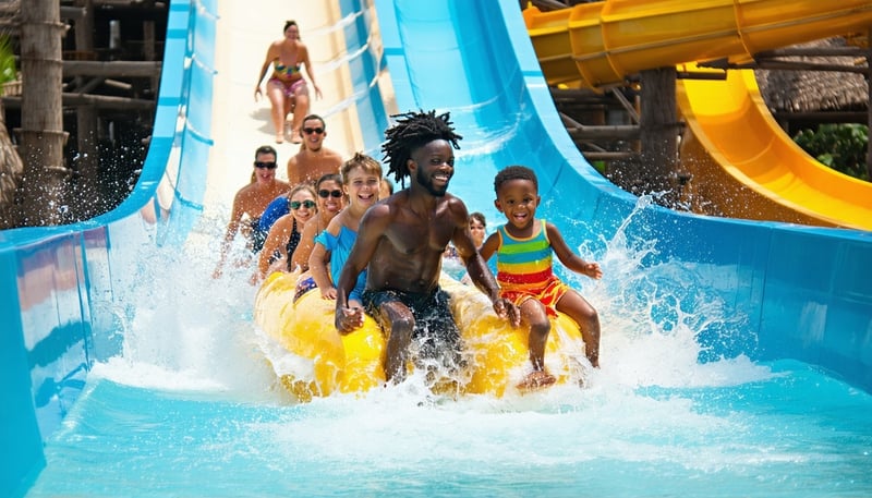 Families and friends enjoying thrilling water slides at a Dubai water park Families and friends enjoying thrilling water slides at a Dubai water park